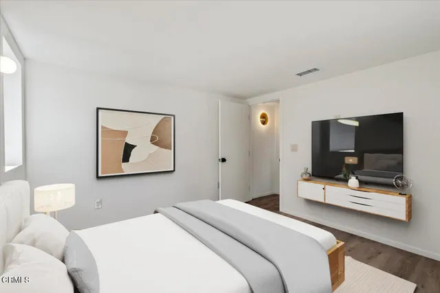 a bedroom with a bed and tv