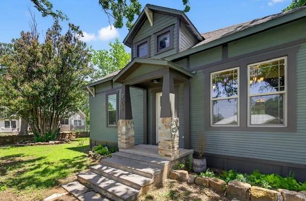 a front view of a house with garden