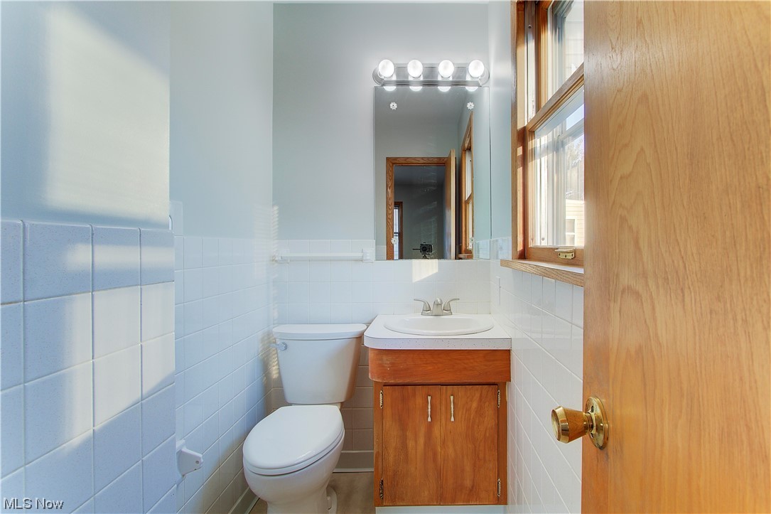 1998 Bridger Road Akron, OH 44312 - Photo 16 of 32 Main bedroom 1/2 Bathroom with tile walls, vanity, and toilet