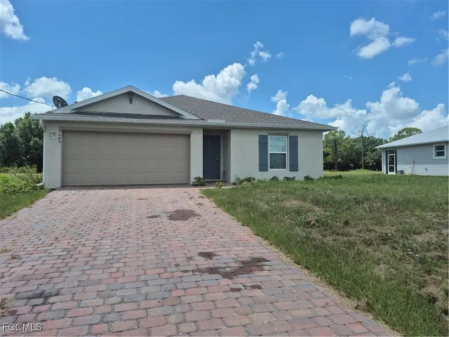 a front view of a house with yard and a garage