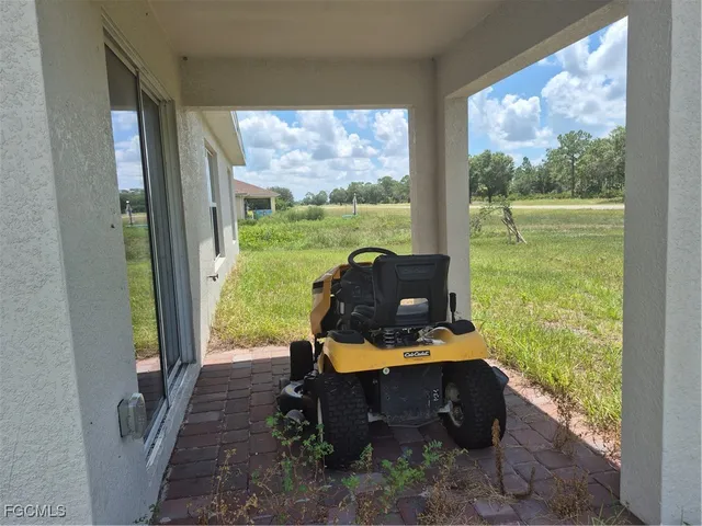 a view of a green field with wooden fence