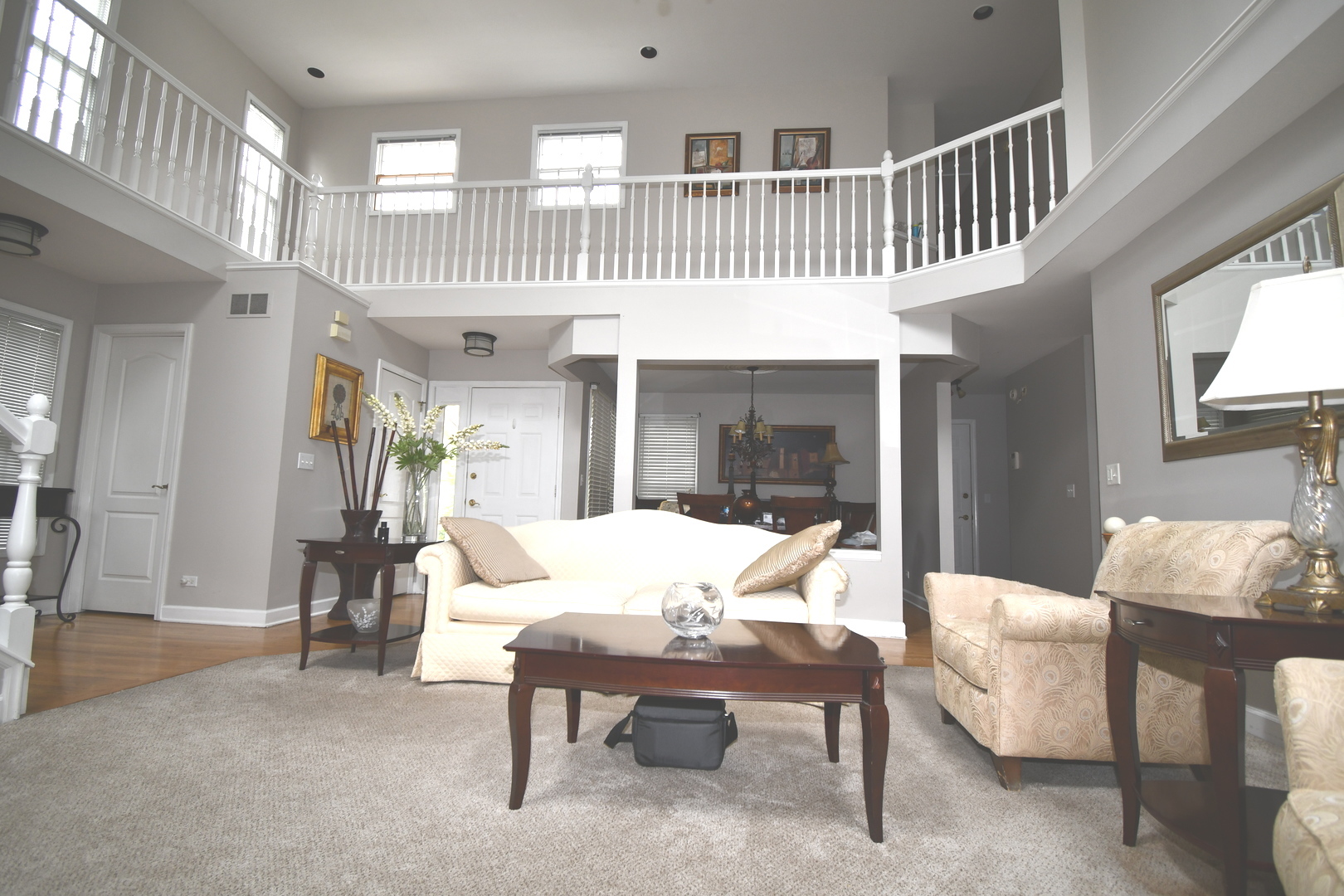 2174 Brookside Lane Aurora, IL 60502 - Photo 13 of 32 a living room with furniture a rug and a chandelier