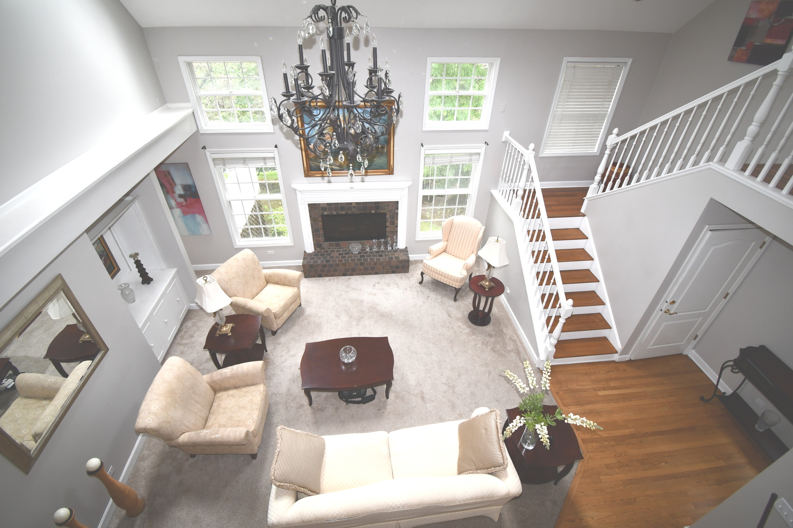 2174 Brookside Lane Aurora, IL 60502 - Photo 18 of 32 a living room with furniture a fireplace and a chandelier