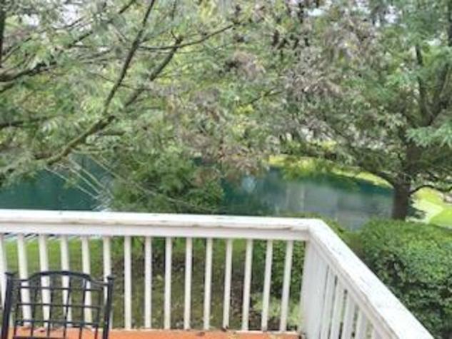 2174 Brookside Lane Aurora, IL 60502 - Photo 2 of 32 a view of balcony with wooden floor and lake view