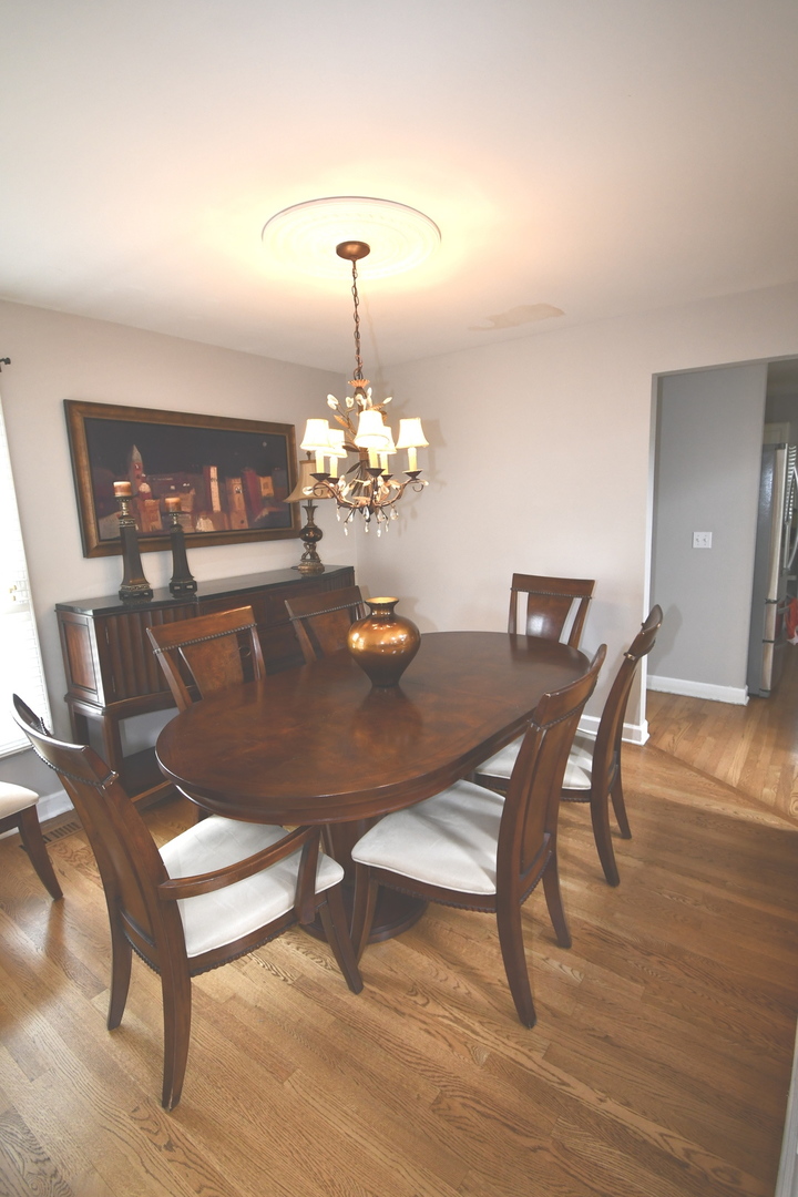2174 Brookside Lane Aurora, IL 60502 - Photo 21 of 32 a view of a dining room with furniture wooden floor and chandelier
