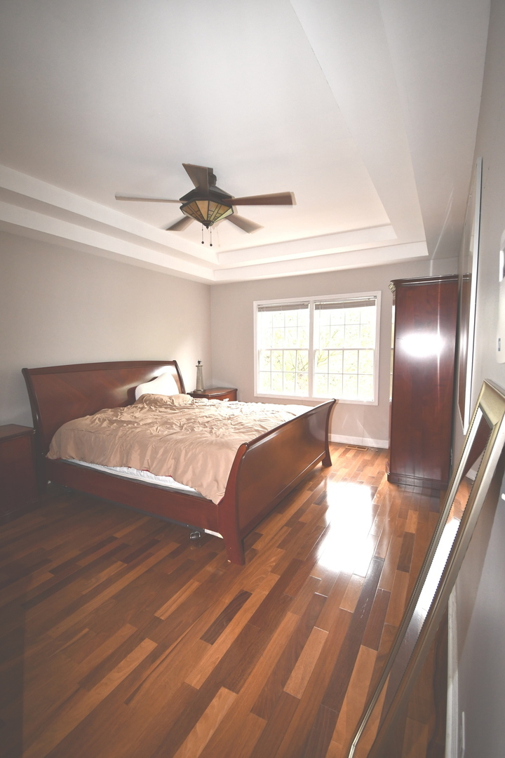 2174 Brookside Lane Aurora, IL 60502 - Photo 24 of 32 a spacious bedroom with a bed and large window