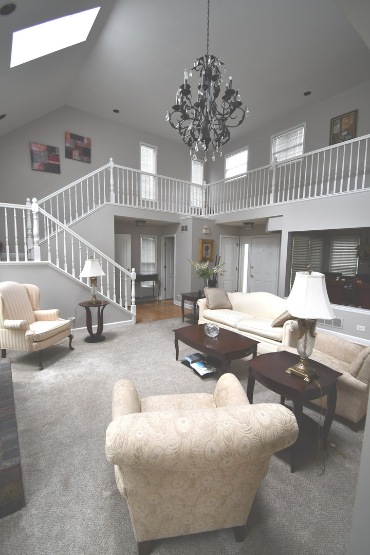 2174 Brookside Lane Aurora, IL 60502 - Photo 3 of 32 a living room with furniture and a chandelier