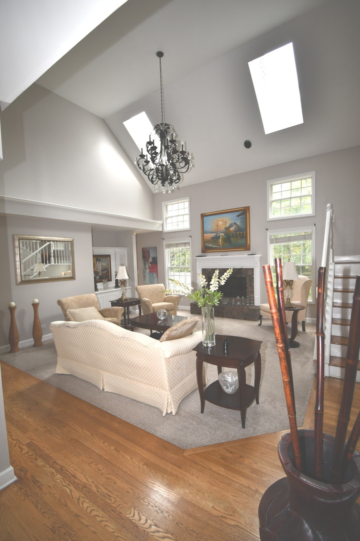 2174 Brookside Lane Aurora, IL 60502 - Photo 5 of 32 a living room with fireplace furniture and a chandelier