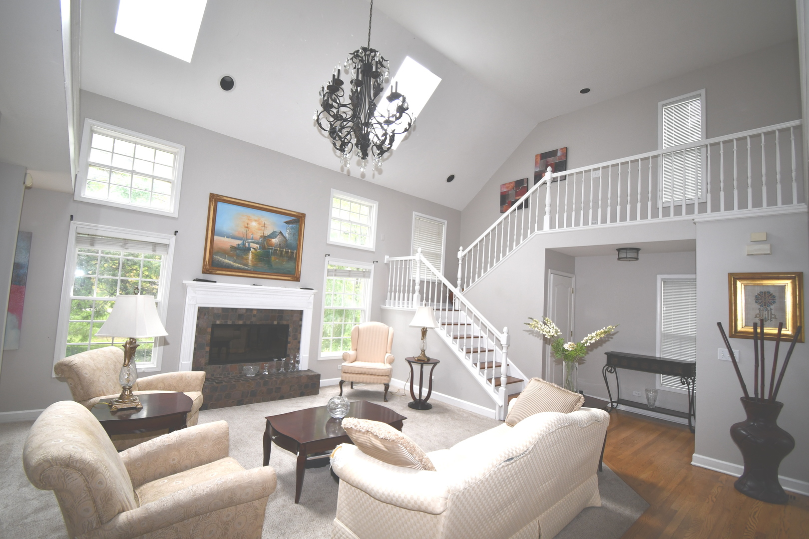 2174 Brookside Lane Aurora, IL 60502 - Photo 7 of 32 a living room with furniture a chandelier and a fireplace