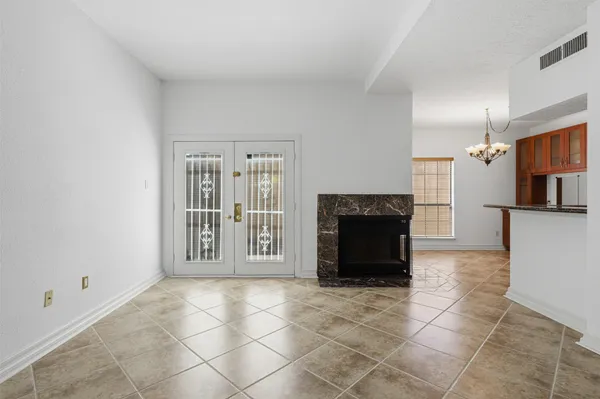 a living room with a fireplace a rug and a window