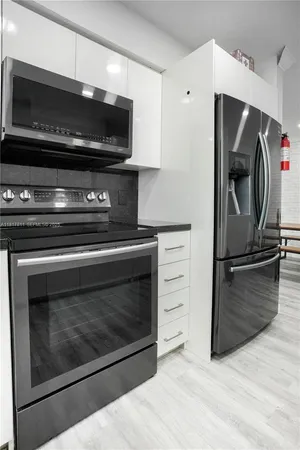 a kitchen with a stove and a microwave