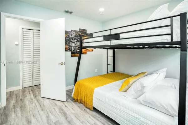 a bedroom with a bed and a walk in closet