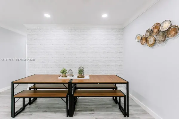 a room with a table and paintings on the wall