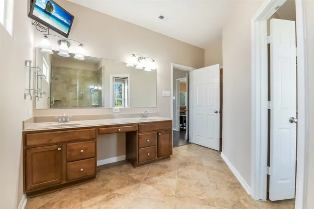 a spacious bathroom with a granite countertop double vanity sink mirror and bathtub