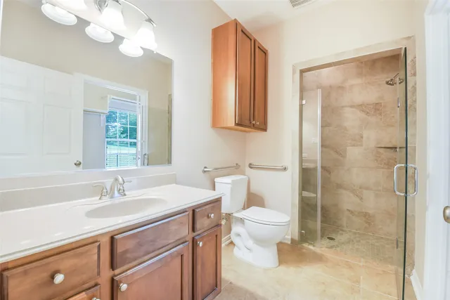 a bathroom with a sink a toilet and a mirror