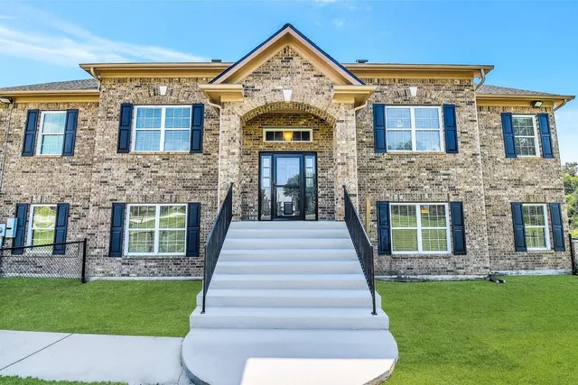 a front view of a house with garden