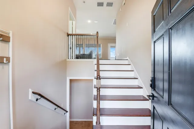 a view of entryway and hall with wooden floor