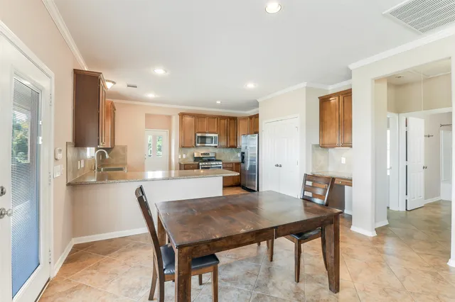 a kitchen with a table and chairs in it