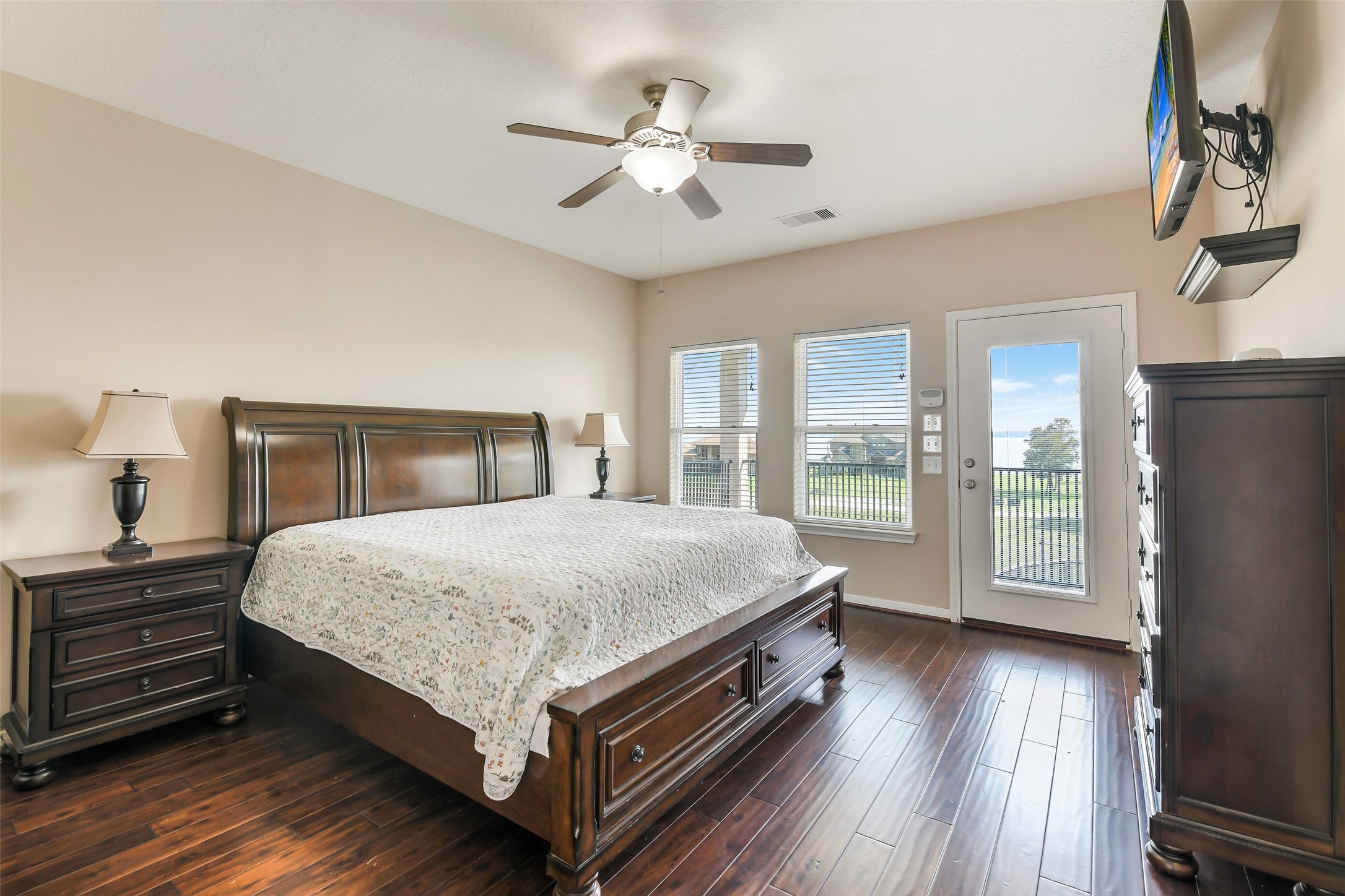 264 Falcon Point Onalaska, TX 77360 - Photo 10 of 33 a bedroom with a large bed a chandelier and dresser