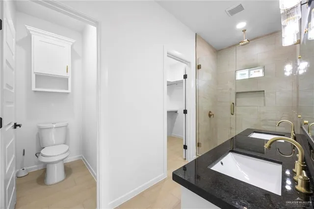 a bathroom with a sink toilet and shower