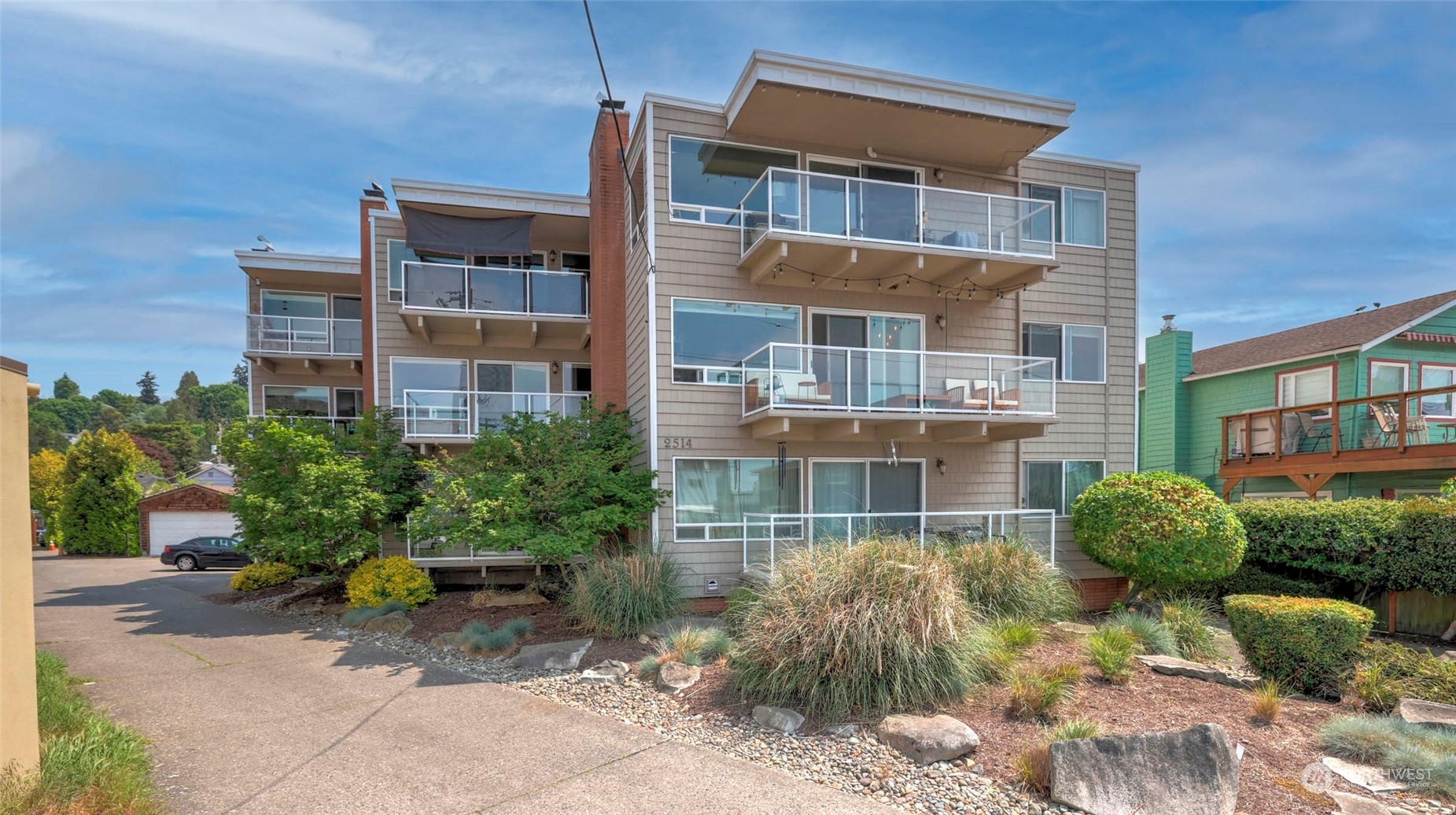 2514 57th Avenue Southwest, Unit 102 Seattle, WA 98116 - Photo 1 of 18 a view of a building with a garden