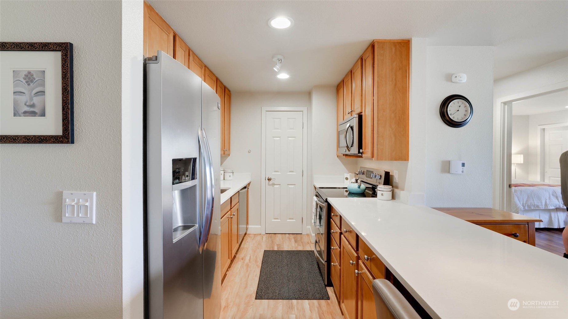 2514 57th Avenue Southwest, Unit 102 Seattle, WA 98116 - Photo 11 of 18 a spacious bathroom with a sink and a large mirror