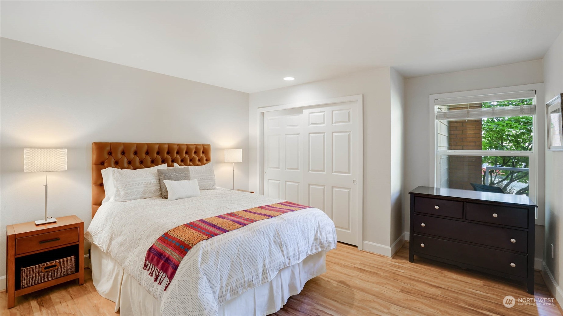 2514 57th Avenue Southwest, Unit 102 Seattle, WA 98116 - Photo 16 of 18 a bedroom with a bed and a window