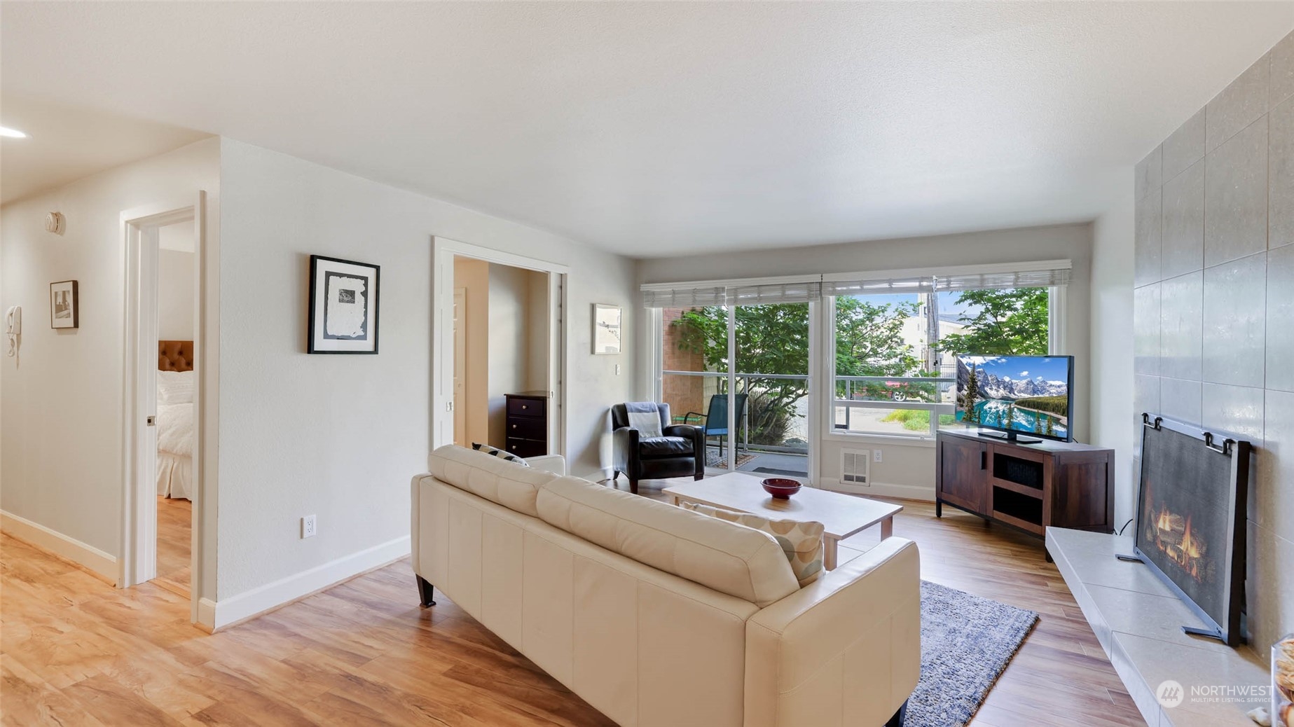 2514 57th Avenue Southwest, Unit 102 Seattle, WA 98116 - Photo 4 of 18 a living room with furniture and large windows