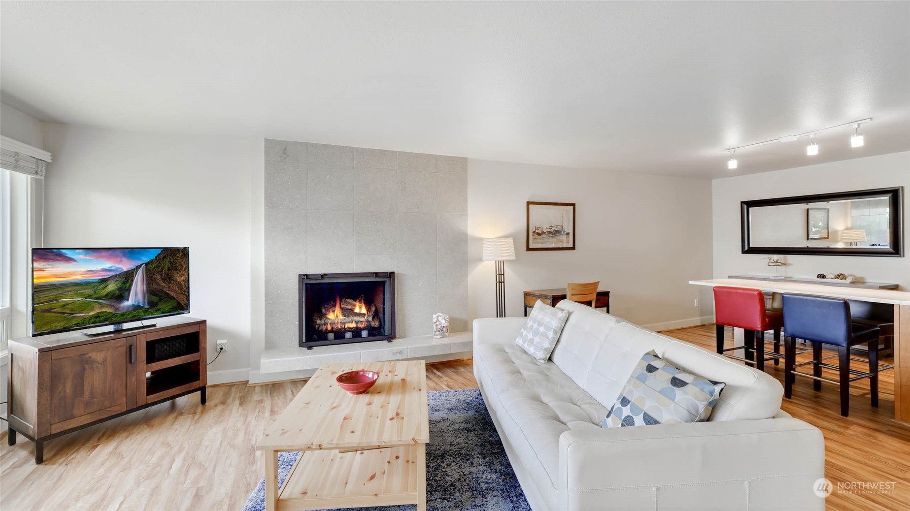 2514 57th Avenue Southwest, Unit 102 Seattle, WA 98116 - Photo 6 of 18 a living room with furniture and a flat screen tv