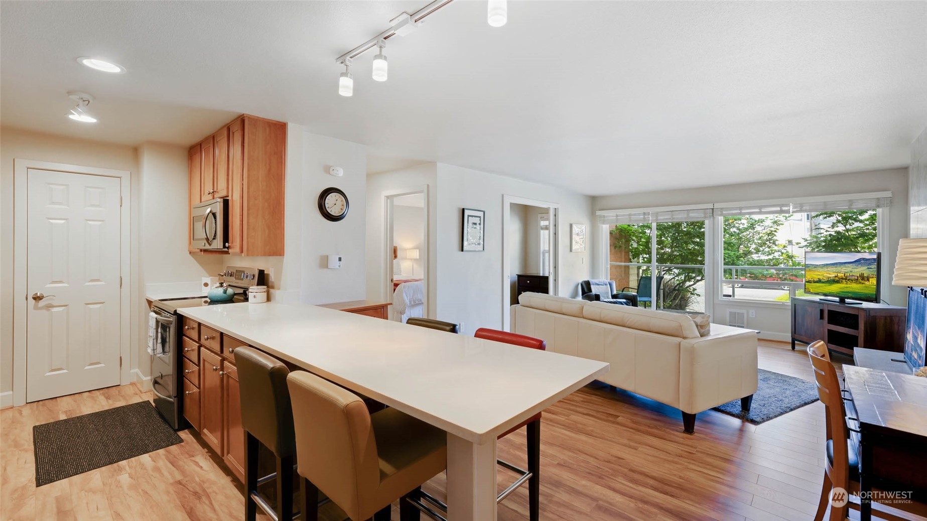2514 57th Avenue Southwest, Unit 102 Seattle, WA 98116 - Photo 10 of 18 a living room with stainless steel appliances furniture a rug and a large window