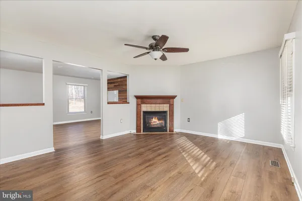 a kitchen with cabinets stainless steel appliances and wooden floor