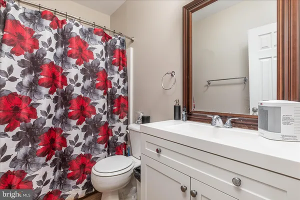 a view of a white house with a big yard and large trees