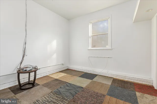 a view of a house with a patio and a yard