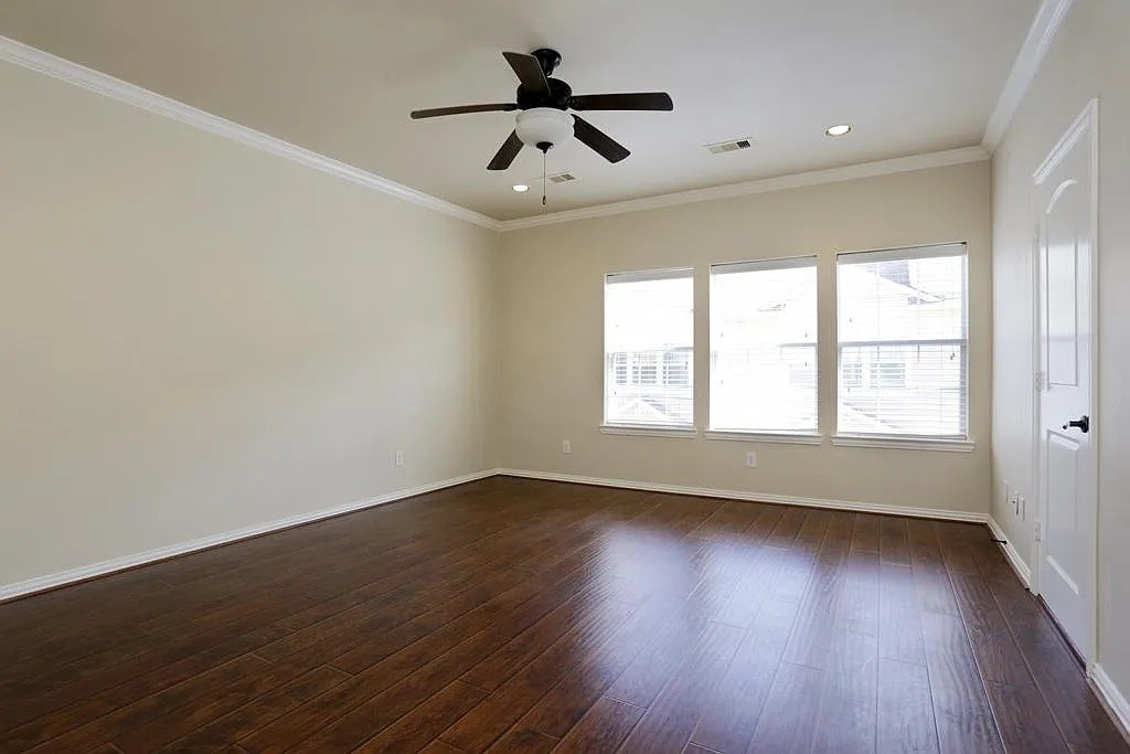 5615 Winsome Lane, Unit H Houston, TX 77057 - Photo 11 of 24 wooden floor in an empty room with a window