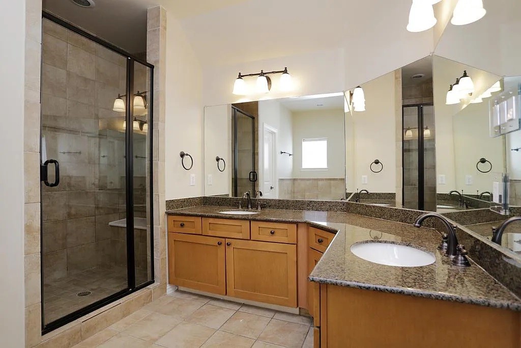 5615 Winsome Lane, Unit H Houston, TX 77057 - Photo 12 of 24 a bathroom with a granite countertop sink and a mirror
