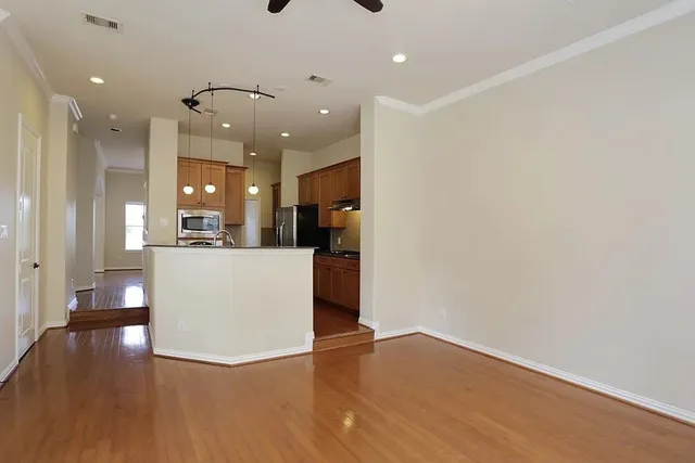 a view of a livingroom with a fireplace wooden floor and windows