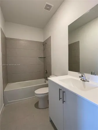 a bathroom with a sink a toilet and bathtub