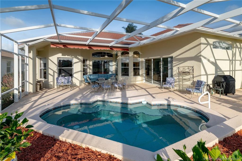 2216 Southeast Stonehaven Road Port St. Lucie, FL 34952 - Photo 34 of 67 a view of a swimming pool with a patio