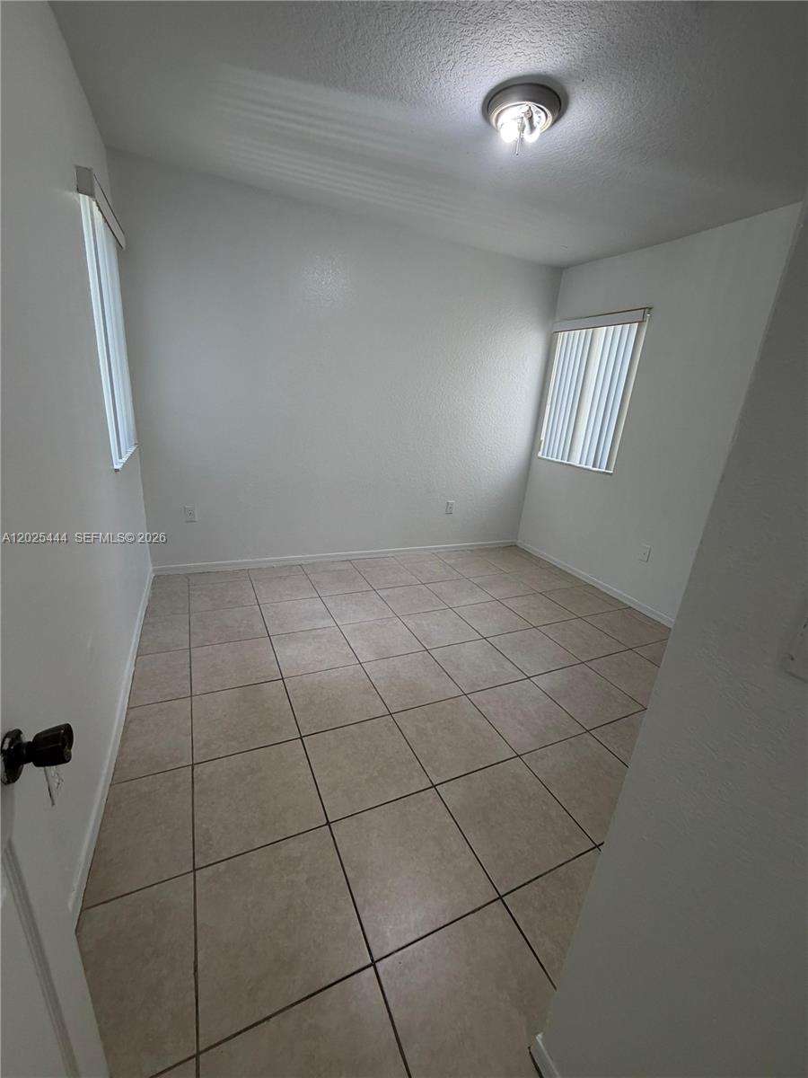 681 Southwest 7th Street, Unit 681 Florida City, FL 33034 - Photo 12 of 16 en empty room with windows