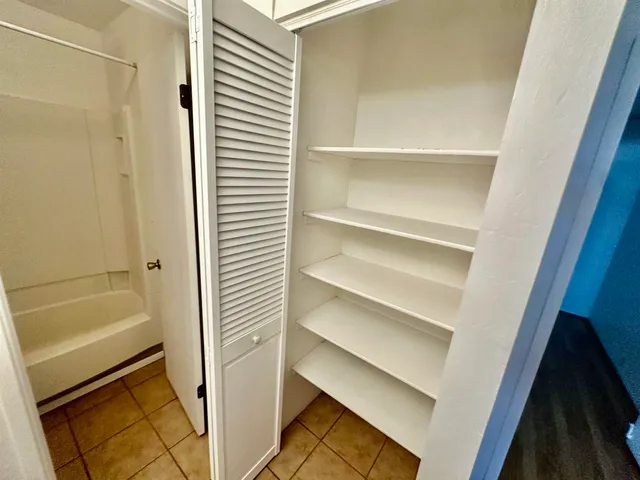 a bathroom with a tub and shower