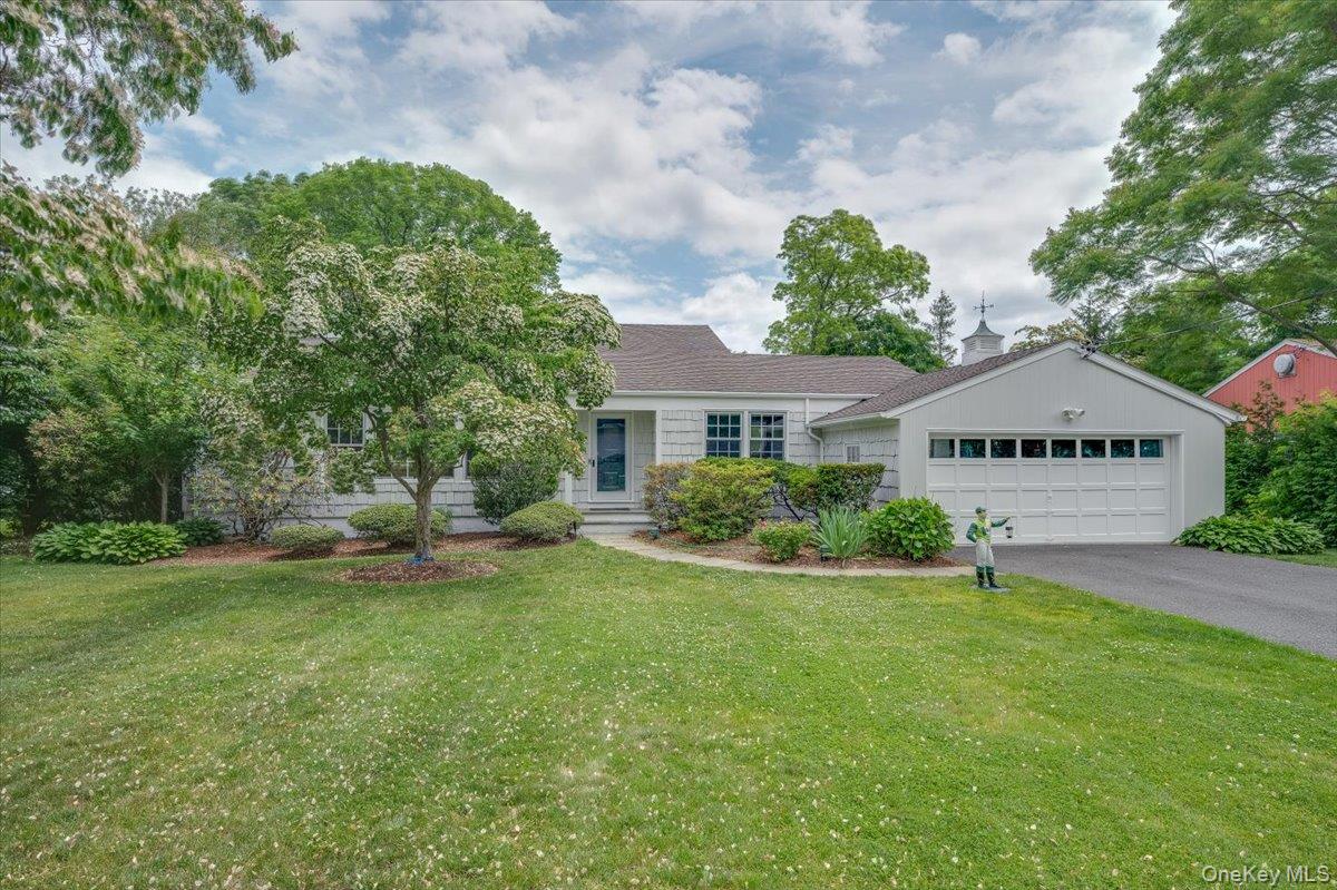4 Wagon Wheel Road Mamaroneck, NY 10543 - Photo 1 of 1 View of front of house with a front lawn, asphalt driveway, and an attached garage