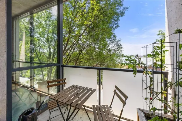 a view of balcony with wooden floor and outdoor seating
