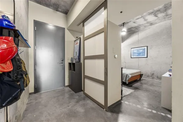 a view of a hallway with workspace and a window