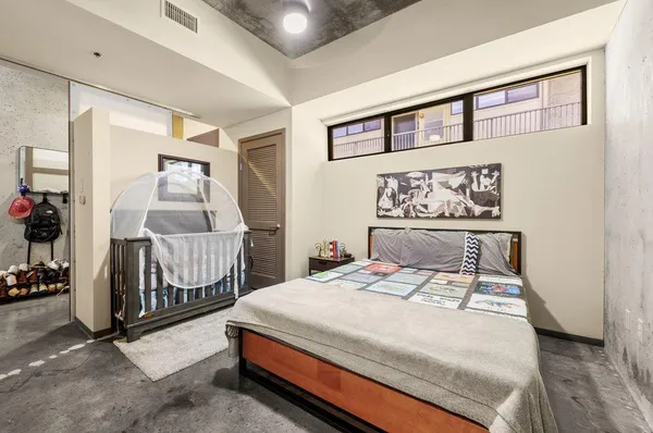 a bedroom with a bed a mirror and a table