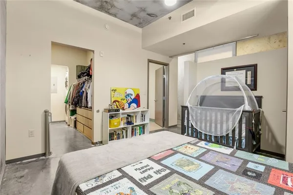 a bedroom with a bed and a window