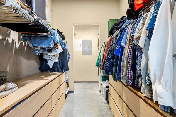 a view of walk in closet with clothes and shoes