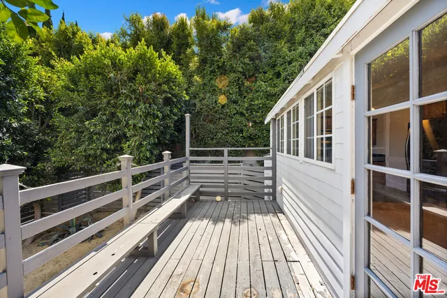 a view of a patio with table and chairs and potted plants