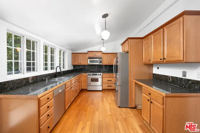 a spacious bathroom with a granite countertop sink and a large window