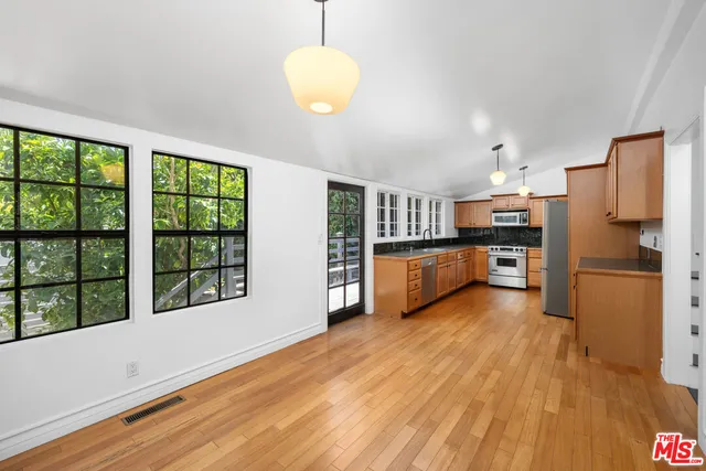 a spacious bedroom with a bed and a chandelier