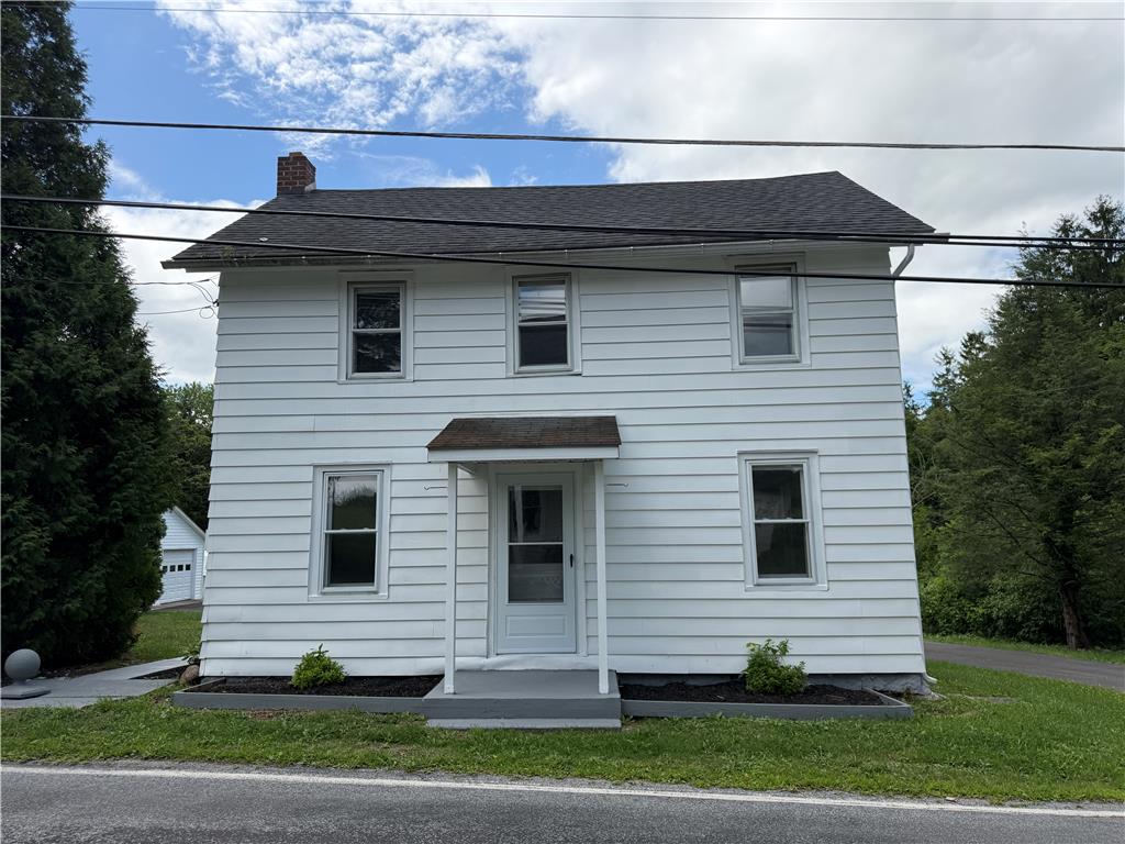 5720 Memorial Road Germansville, PA 18053 - Photo 2 of 30 White siding and a dark roof define this inviting two-story home, nestled among lush greenery.